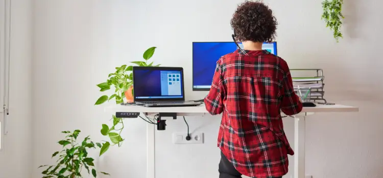A woman at standing desk searching for best storage add-ons
