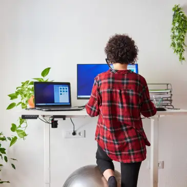 Standing Desk Storage ideas woman at office desk with laptops