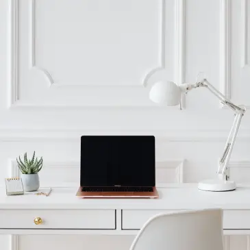 White desk with lamp and plant